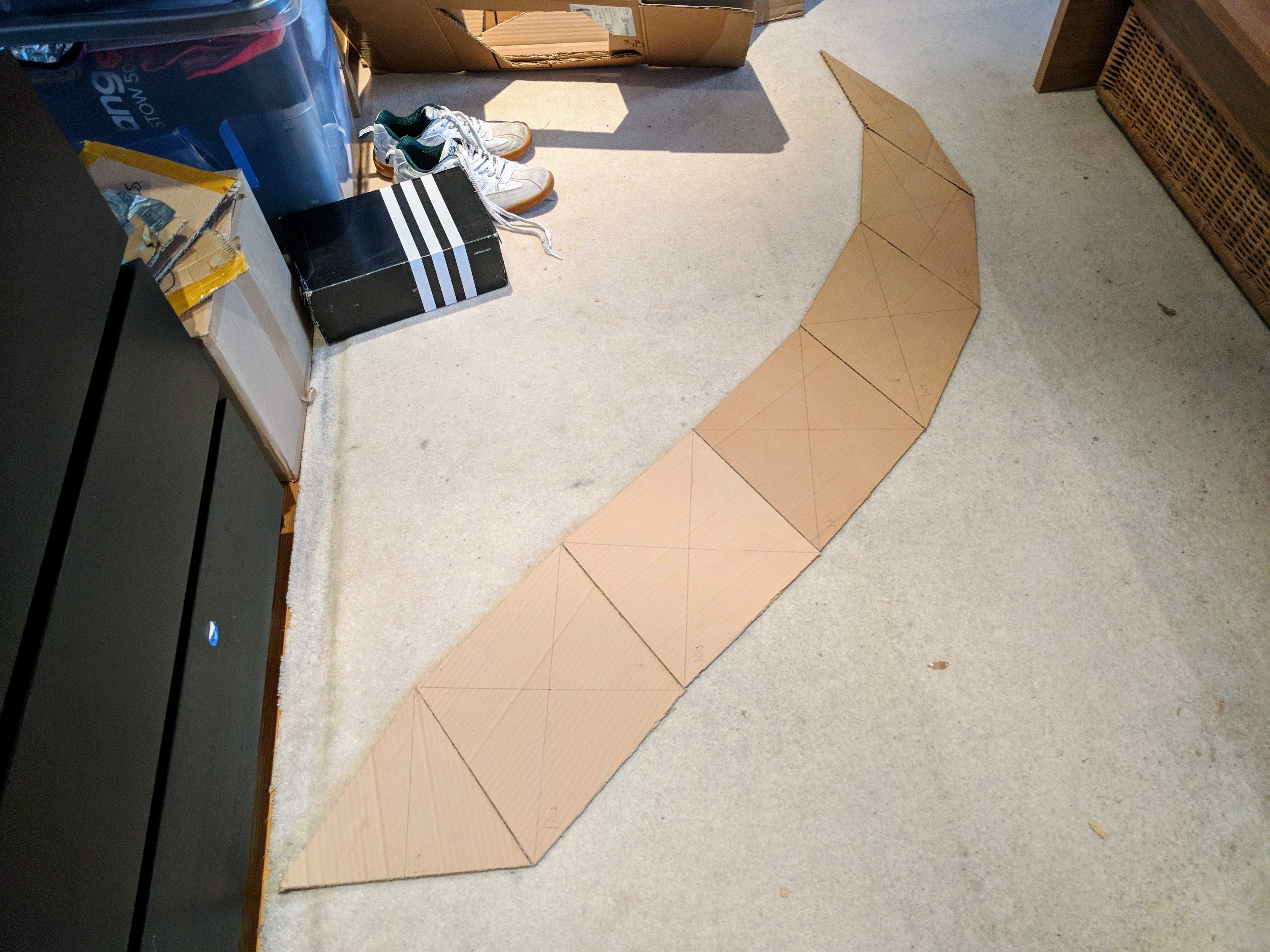 Building a 1.4m high polar zonohedron dome ('zome') on Saturday. First strip cut out of cardboard.